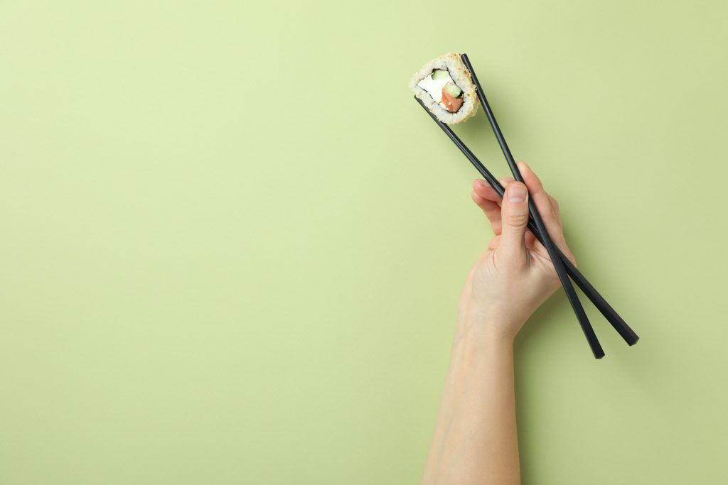 Sushi held with chopsticks
